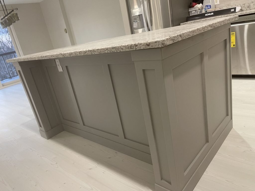 Granite-top island with painted panel detailing