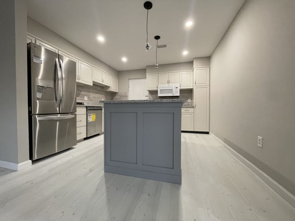 Open kitchen with panelled island and recessed lighting