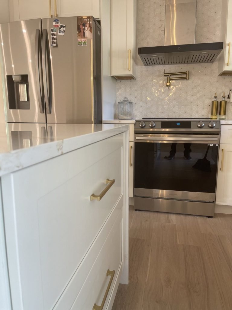 Brushed brass cabinet pulls on a white kitchen island