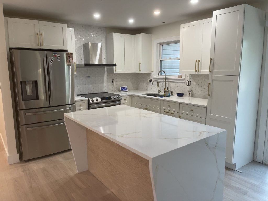 Kitchen island with quartz waterfall edge and stainless appliances