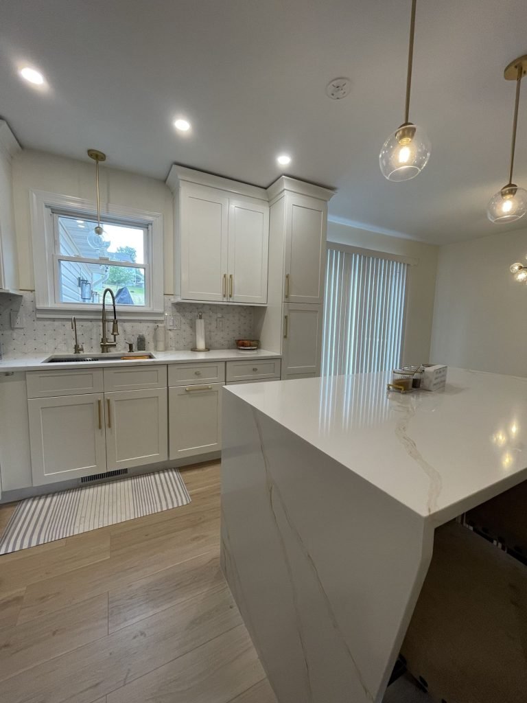 Quartz island with pendant light in a renovated kitchen