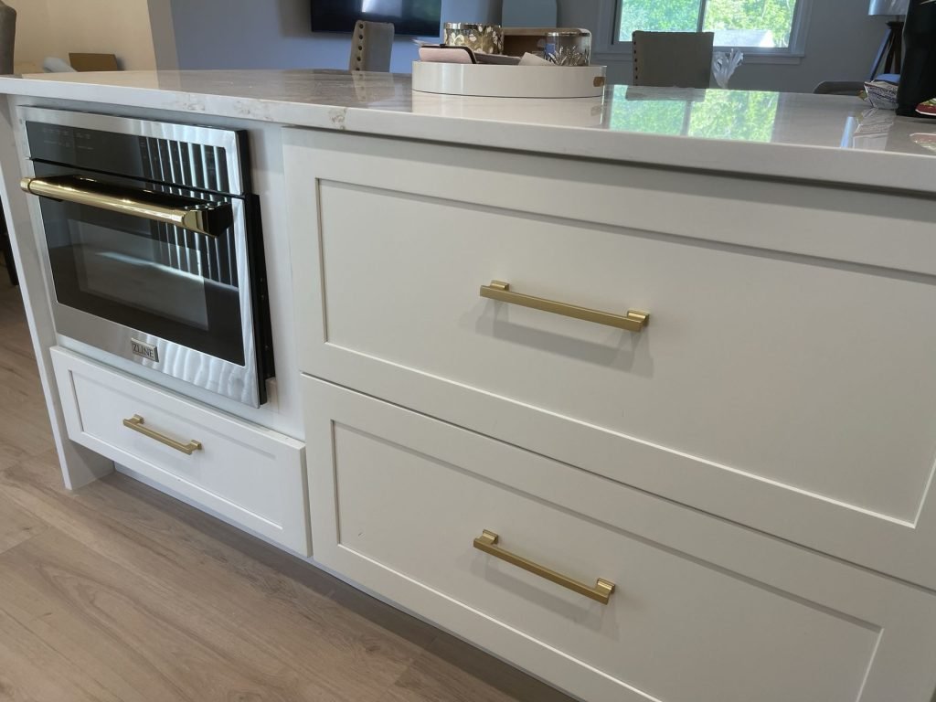 Kitchen island with built-in microwave drawer and brass pulls