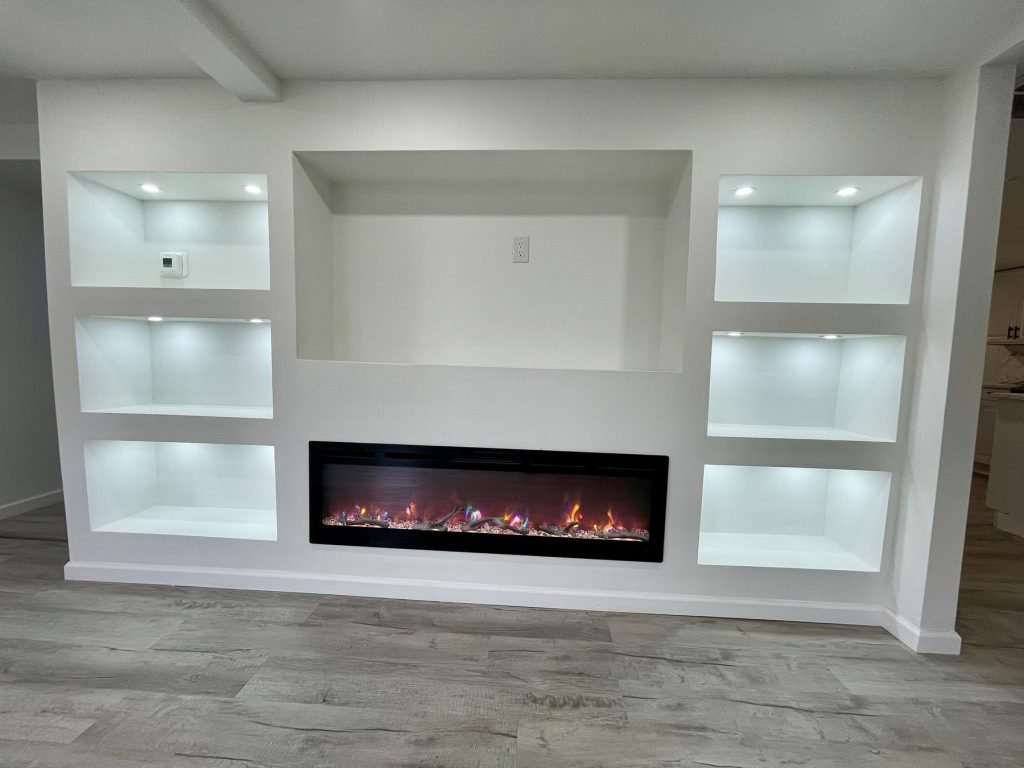 Built-in entertainment wall with recessed LED niches and fireplace