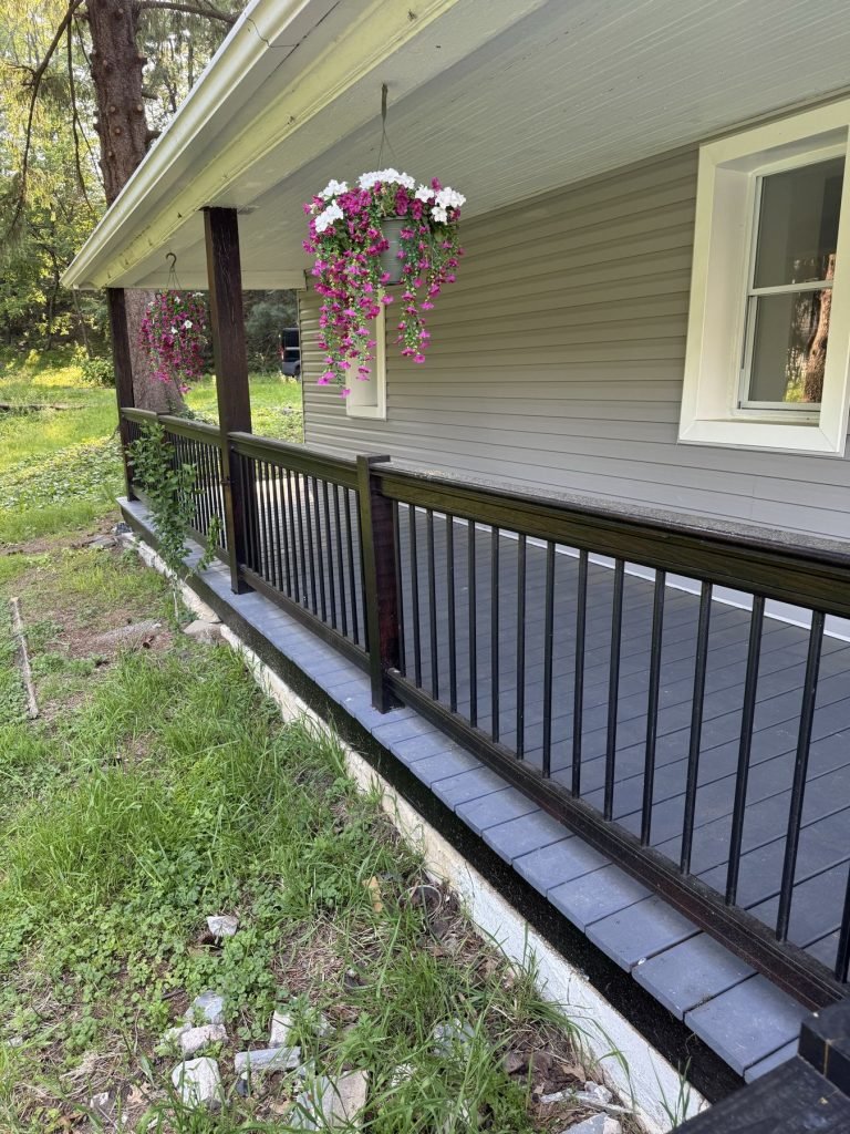 Front porch with new black balusters and painted deck