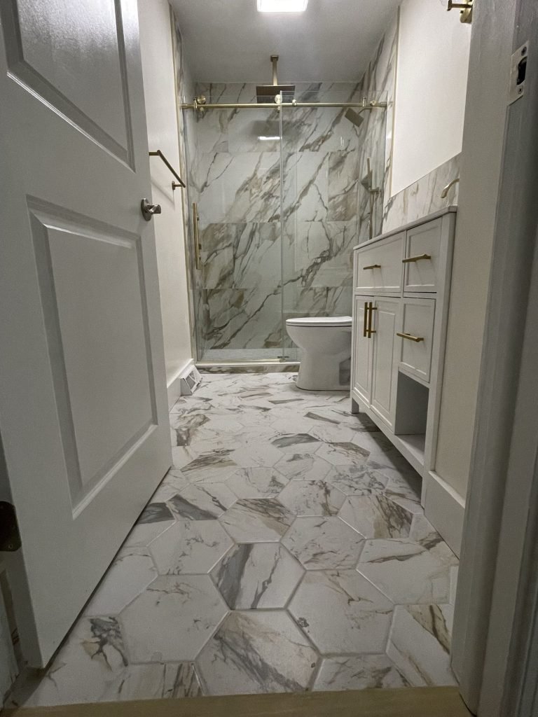 Bathroom with hexagon marble-look floor tile and walk-in shower