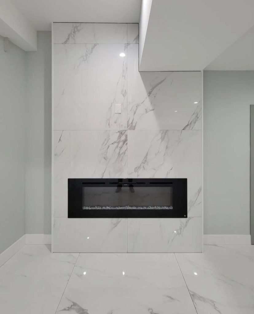 Floor-to-ceiling marble-look tile fireplace surround