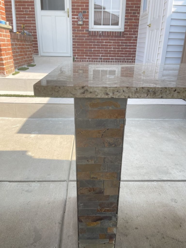 Stacked stone column supporting a granite bar top