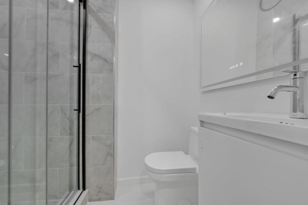 White bathroom remodel with glass shower