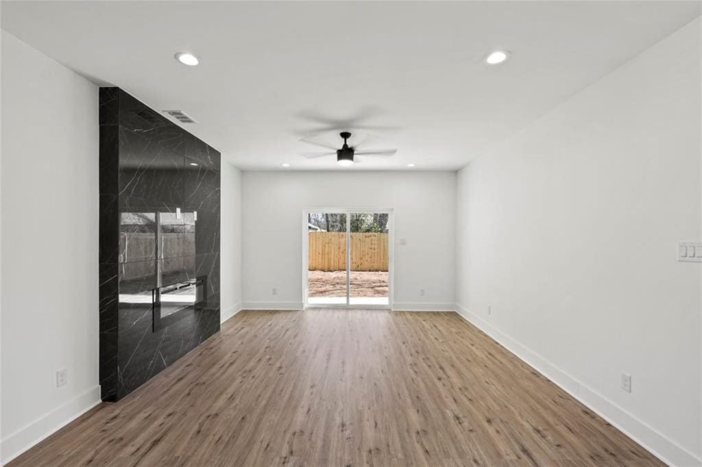 White kitchen with island and pendant lighting after a full rowhouse renovation