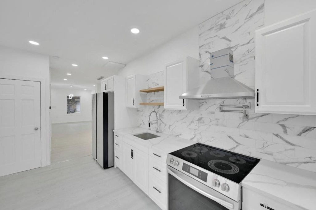 White galley kitchen with marble-look backsplash
