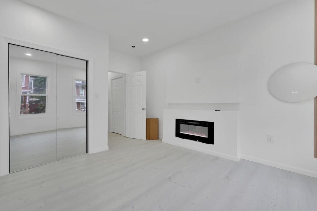 Bright living room with linear fireplace after renovation