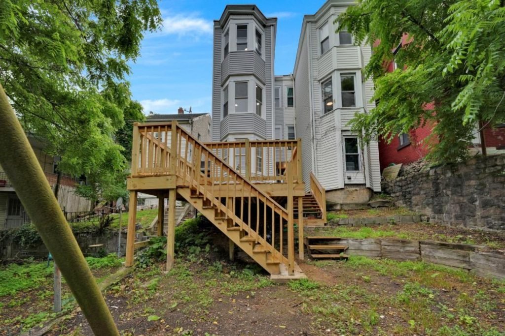 New wood deck and stairs behind a Reading rowhouse